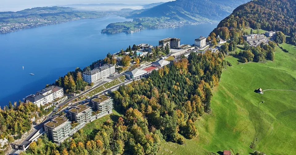The Bürgenstock resort on its cliff seen from above, the lake far below
